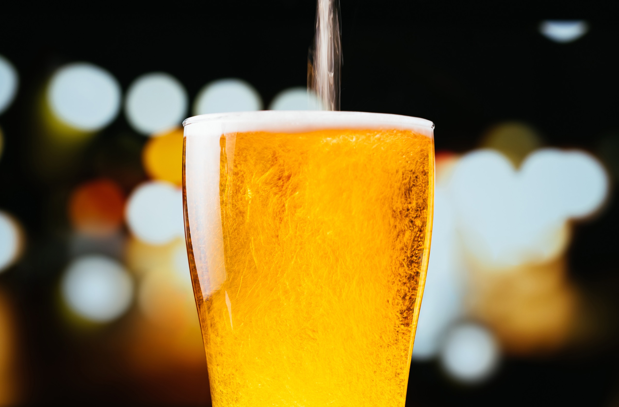 A beer glass being topped off