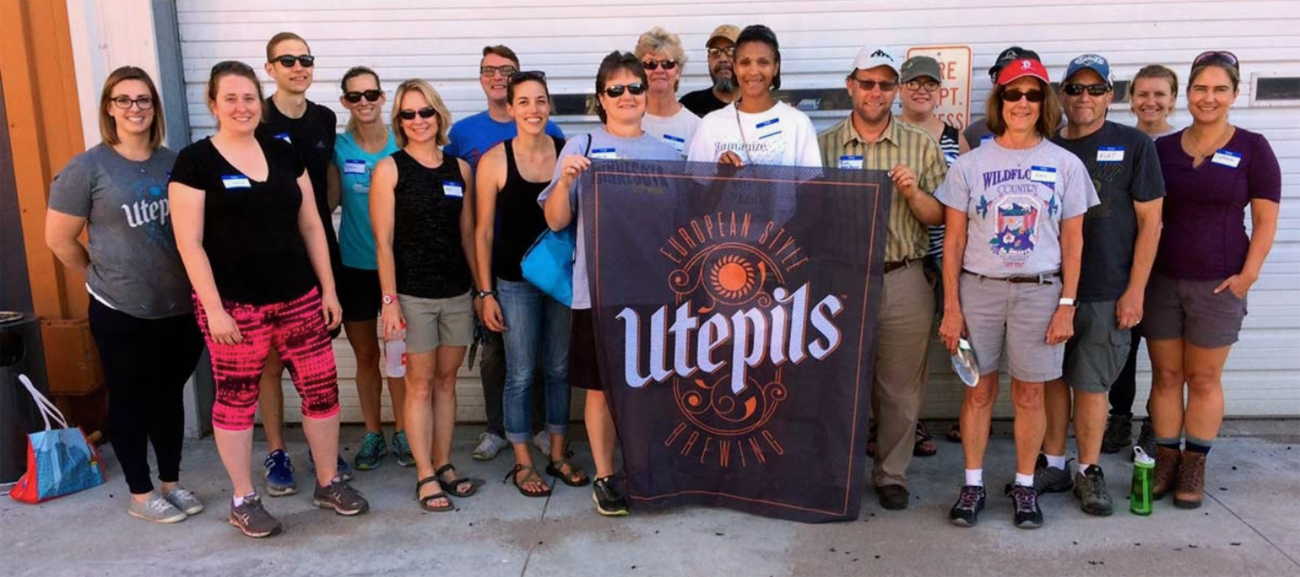 The DuGood Team picture behind a Utepils banner