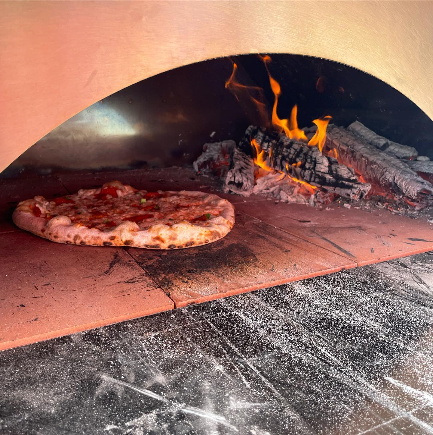 Pizza baking in a stone oven